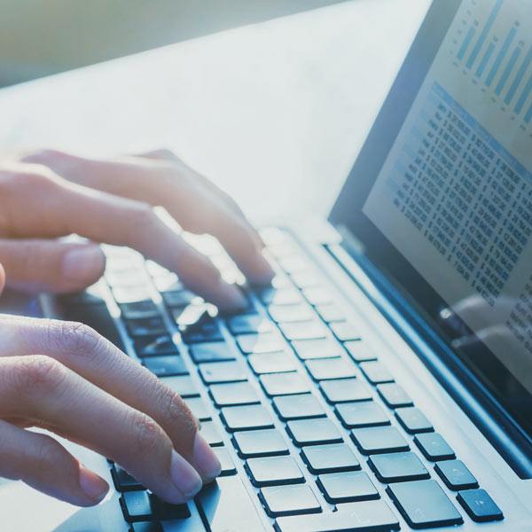 person typing on laptop